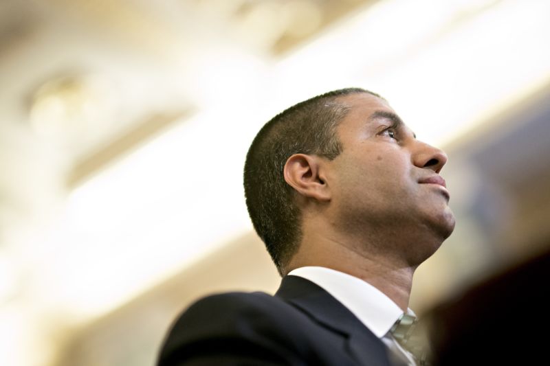 FCC Chairman Ajit Pai seen from the side as he listens during a Senate committee hearing.