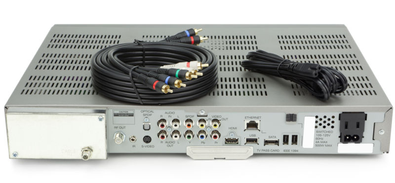 A cable TV set-top box, with cables laying on top.
