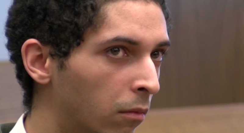 Accused man sits in court.