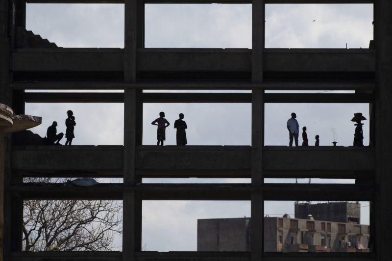 Mozambiqueans are seen at desolated buildings following the Cyclone Idai in Sofala region in Beira, Mozambique on March 31, 2019.