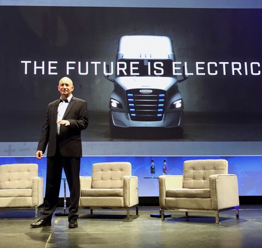 Roger Nielsen, president and CEO of Daimler Trucks North America standing on a stage.