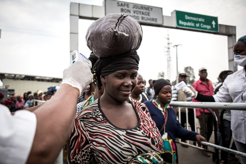A woman gets her temperature measured at an Ebola screening station as she enters Rwanda from the  Democratic Republic of the Congo on July 16, 2019 in Goma.