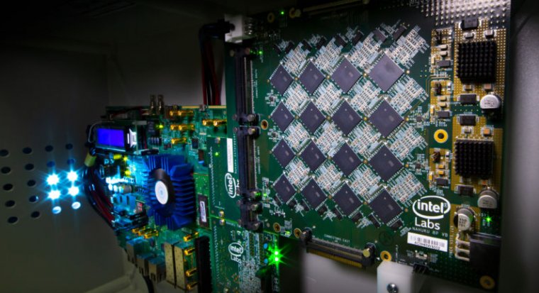 This is a picture of Intel’s Nahuku boards, which contain 8 to 32 Intel Loihi neuromorphic chips, interfaced to an Intel Arria 10 FPGA development kit. Intel’s latest neuromorphic system, Pohoiki Beach, is made up of multiple Nahuku boards and contains 64 Loihi chips.