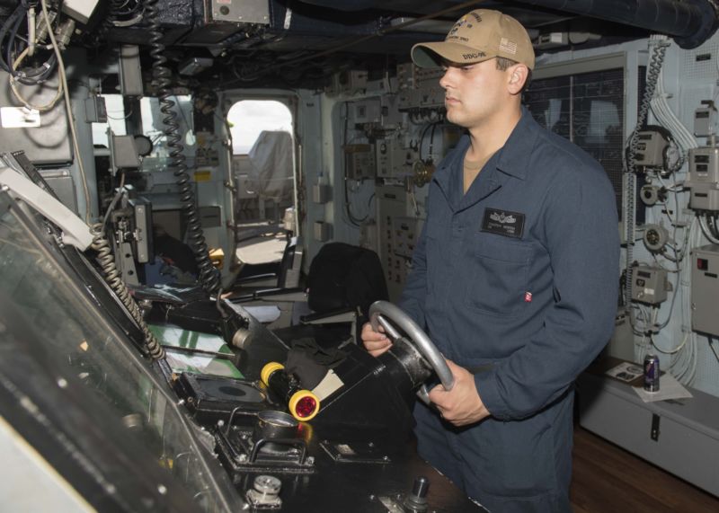 Seaman Timothy North stands watch as the helmsman on the bridge of the Arleigh Burke-class guided-missile destroyer USS Forrest Sherman (DDG 98). Forrest Sherman is participating in a sustainment exercise with the Harry S. Truman Carrier Strike Group, an integrated, comprehensive exercise designed to ensure the strike group is ready to meet all mission sets and carry out sustained combat operations from the sea. (U.S. Navy photo by Mass Communication Specialist 3rd Class Raymond Maddocks/Released)