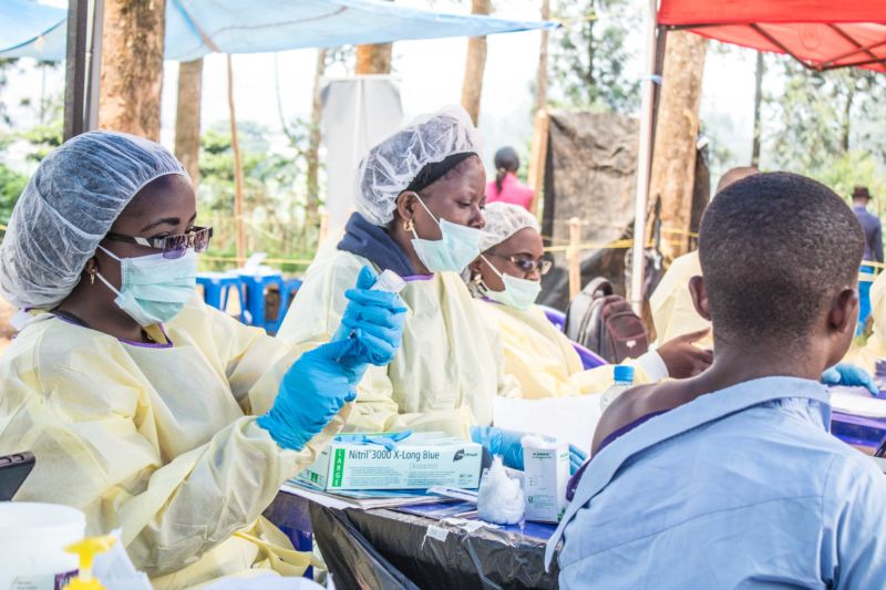 BUTEMBO, CONGO - JULY 27: A healthcare member inoculates a man for Ebola suspicion to take precautions against the disease in Butembo, Democratic Republic of the Congo.