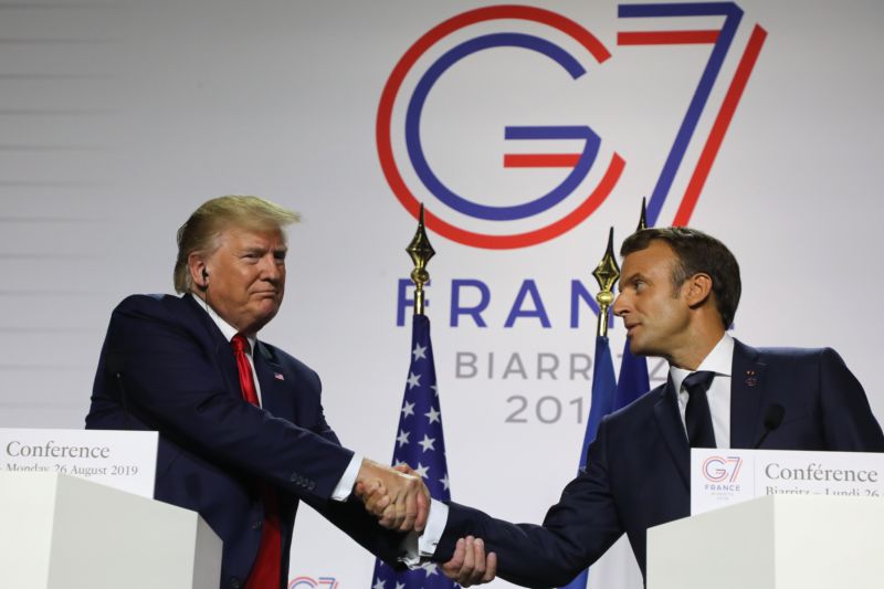 France's President Emmanuel Macron (R) and US President Donald Trump shake hands during a joint-press conference in Biarritz, France, on August 26, 2019.