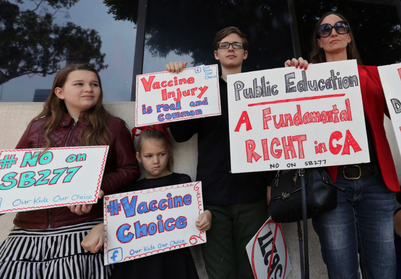 LOS ANGELES, Calif. - APRIL 14, 2015: Kathleen Miller, 46, right, with her children  at a rally of parents and teachers who oppose efforts to end the personal-belief exemption on vaccinations. 