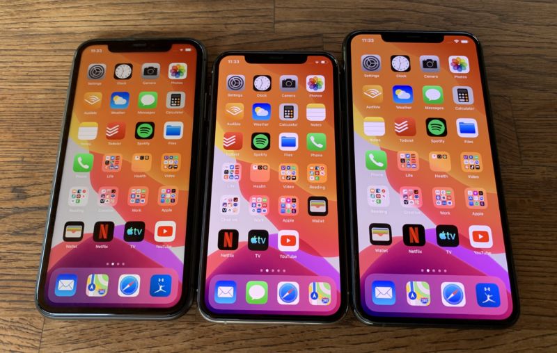 Multiple smartphones on table.