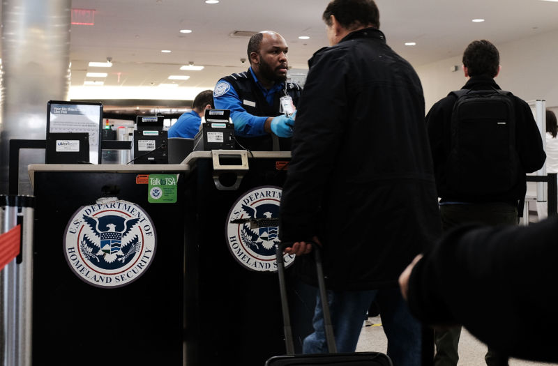 NEW YORK, NY - NOVEMBER 22: A Transportation Security Administration (TSA) worker screens passengers at LaGuardia Airport (LGA) on the day before Thanksgiving, the nation's busiest travel day on November 22, 2017 in New York City. 
