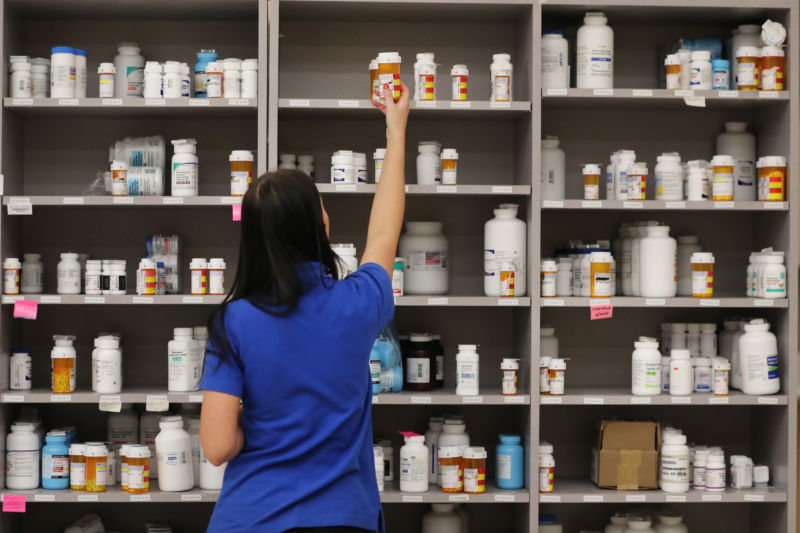 A pharmacy technician grabs a bottle of drugs off a shelve at the central pharmacy of Intermountain Heathcare on September 10, 2018 in Midvale, Utah. IHC along with other hospitals and philanthropies are launching a nonprofit generic drug company called "Civica Rx" to help reduce cost and shortages of generic drugs. 
