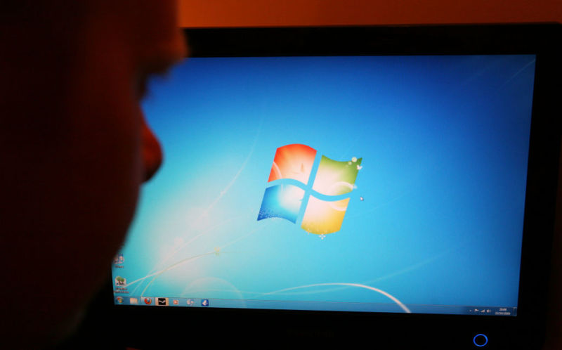 A man looks at the home screen for the "new" Windows 7 platform when it was  launched in October 2009.  Microsoft has ended support, but the OS lives on.
