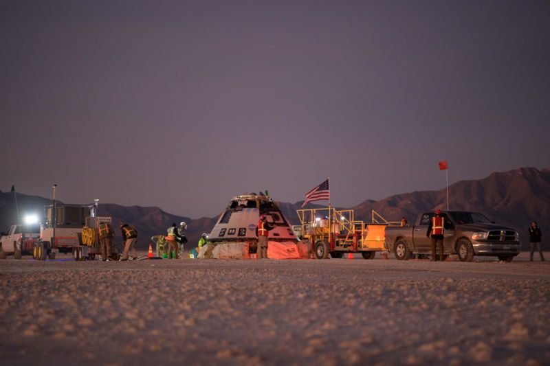 Boeing, NASA, and U.S. Army personnel work around the Boeing CST-100 Starliner spacecraft shortly after it landed in December.