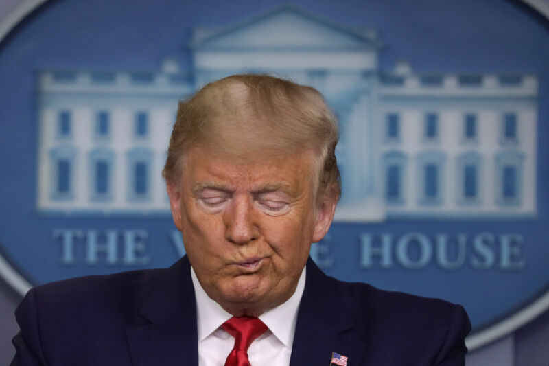 a close up of Trump's face, with his mouth twisted.