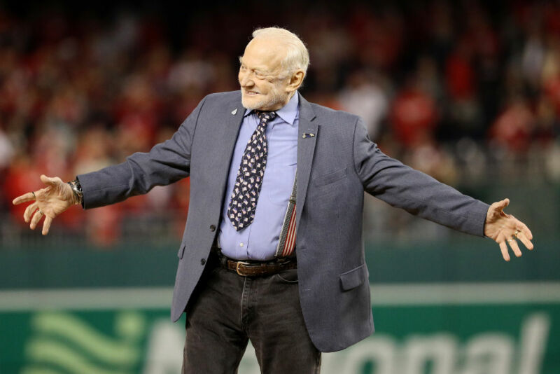 A cheerful old man in a baseball field.