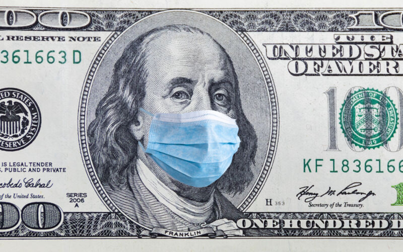 Image of 100-dollar bill with a surgical mask photoshopped across Benjamin Franklin's face.