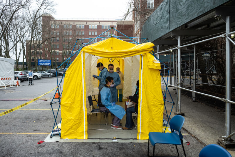 NEW YORK, NY - MARCH 20: Doctors test hospital staff with flu-like symptoms for COVID-19 at St. Barnabas hospital on March 20, 2020, in New York City. St. Barnabas hospital in the Bronx set-up tents to triage possible COVID-19 patients outside before they enter the main Emergency department area. 