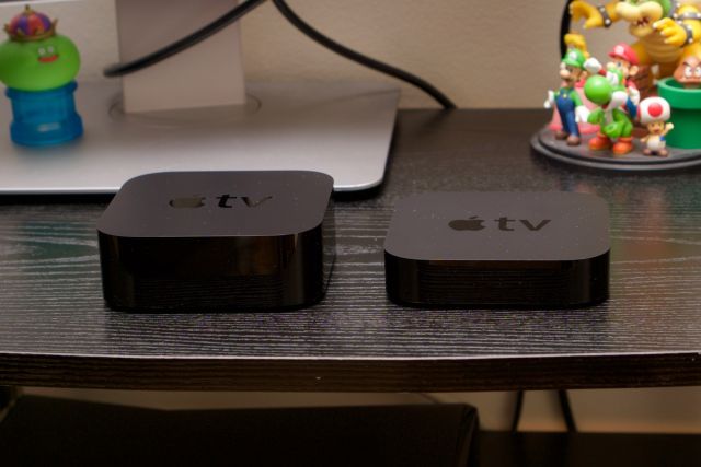 The fourth-generation Apple TV (left) next to the third-gen model.