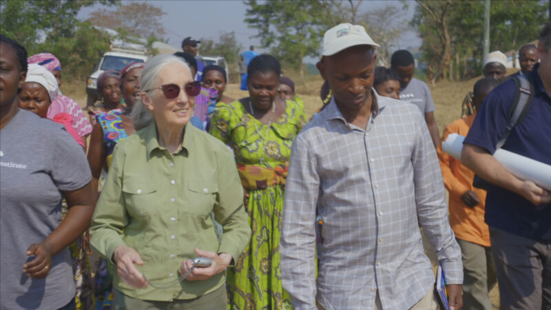 Dr. Jane Goodall walking with local villagers and staff members of TACARE, one of the many programs of the Jane Goodall Institute.