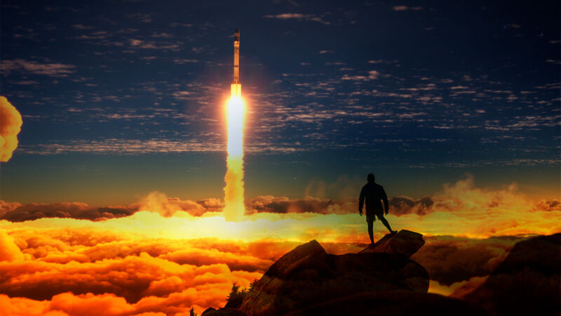 Photoshopped image of a silhouetted person watching a rocket liftoff.