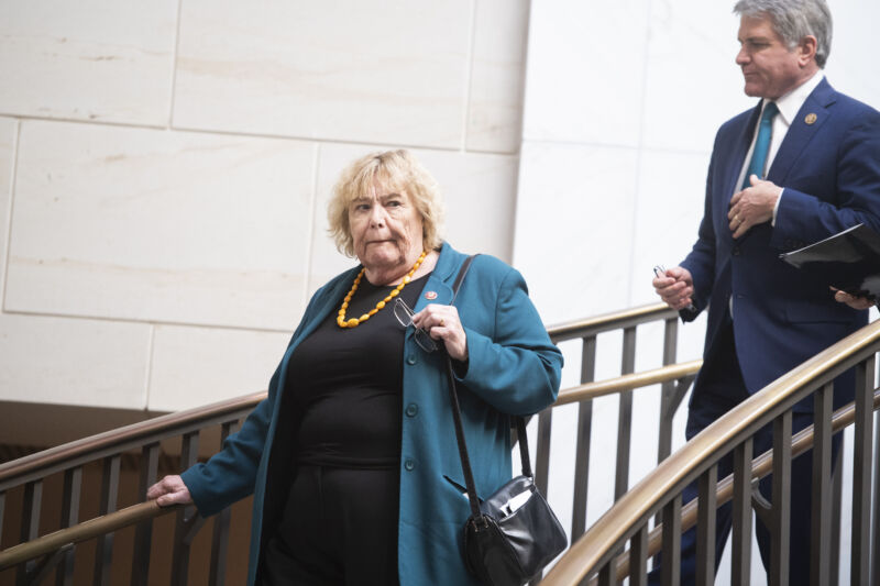 A well-dressed woman descends a flight of stairs.