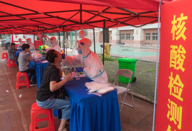 WUHAN, May 15, 2020 - Residents take nucleic acid tests at a testing post set up at a primary school in Dongxihu District in Wuhan, central China's Hubei Province, May 15, 2020. Wuhan will arrange nucleic acid tests for all residents who have not been tested before, in order to better know the number of asymptomatic cases of the novel coronavirus.