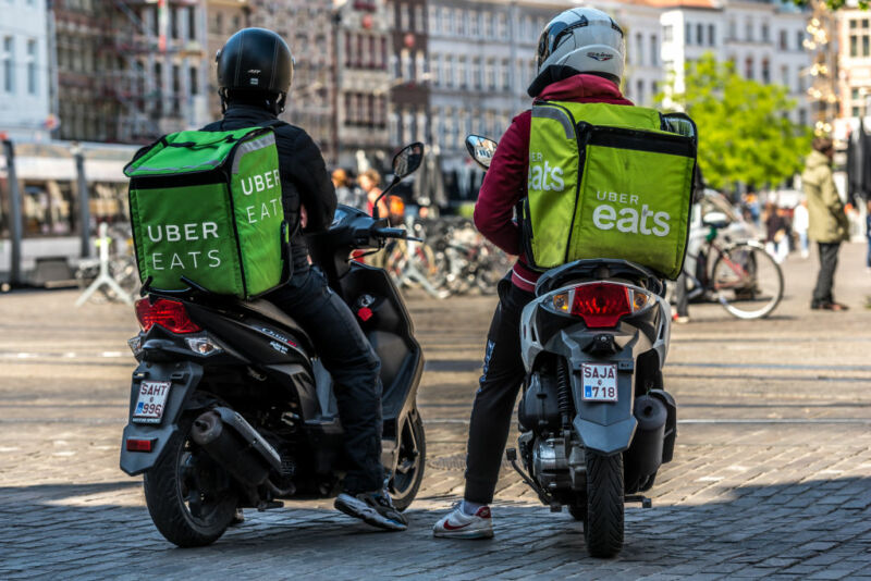 Two Uber Eats delivery courier wait outside Mc Donalds fast food in Ghent, Belgium on May 14, 2020. As Belgium takes steps in easing Restrictions, Restaurant and cafe are not allowed to open to customers only fast food and take away is allowed. restaurants and restaurants may not reopen before June 8.  (Photo by Jonathan Raa/NurPhoto via Getty Images)