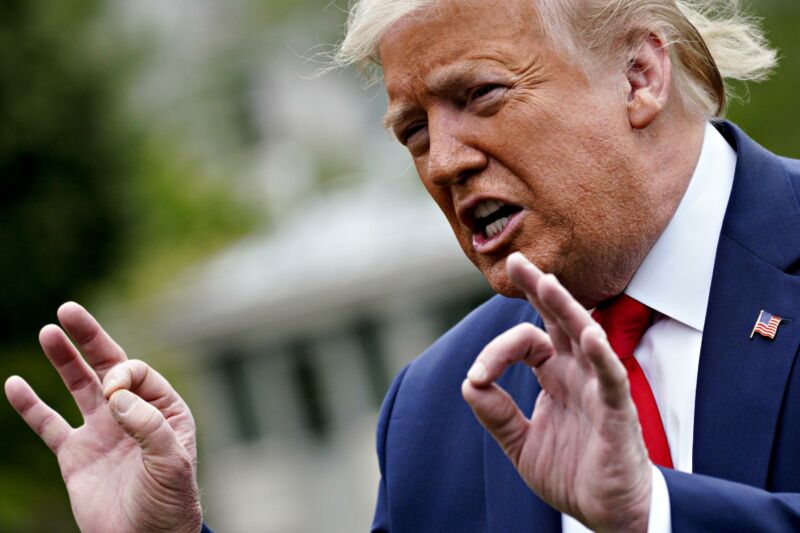 President Donald Trump speaking and gesturing with his hands.