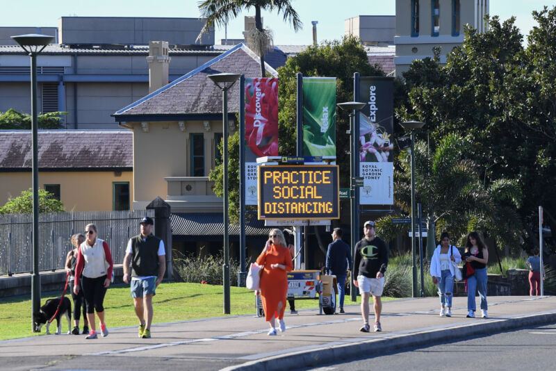 People walk past a social distancing sign outside the Royal Botanic Garden on May 31, 2020 in Sydney, Australia. Policy decisions to re-open facilities or to encourage citizens to shelter in place don't come out of nowhere—there's often (hopefully) data behind the scenes.