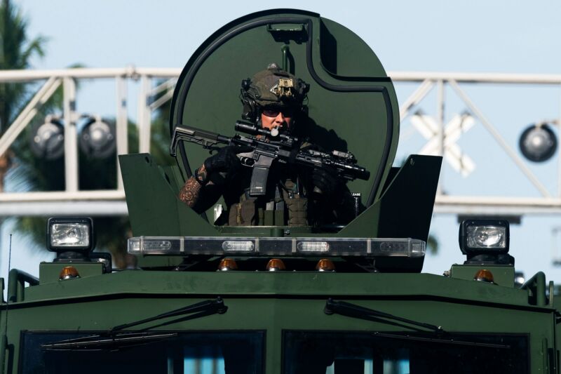 A Miami Police officer watches protesters from an armored vehicle on May 31, 2020.