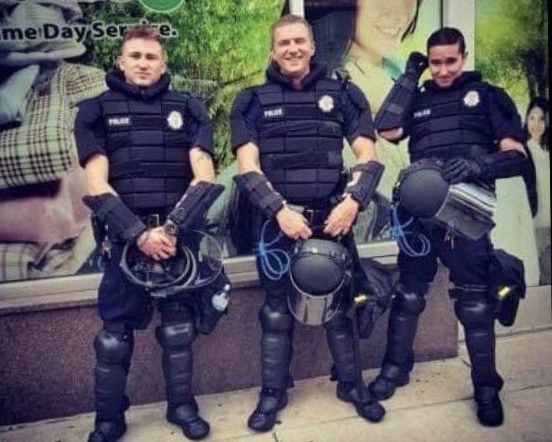 Tommy McClain, left, poses with two other officers in a photo that has since been taken down from Instagram.