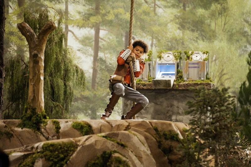 A young contestant swings across a padded foam chasm in an attempt to be the first team to obtain and assemble four lightsaber pieces. 