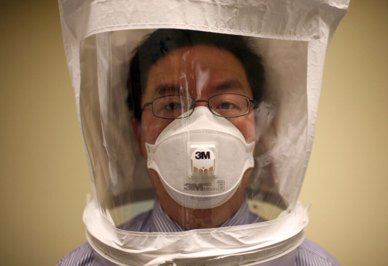 A doctor wears a hood as he tests the seal of an N95 respiratory mask during a training at the La Clinica San Antonio Neighborhood Health Center in California.