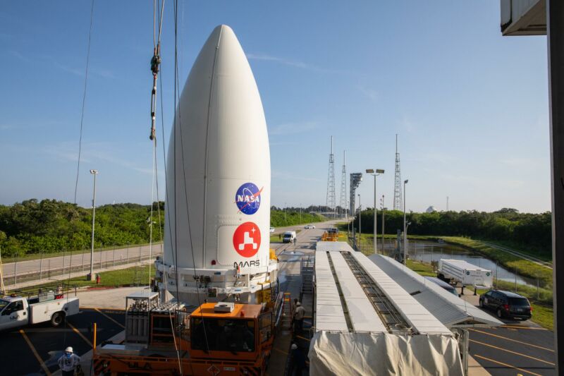 The top stage of a rocket is being transported outdoors.