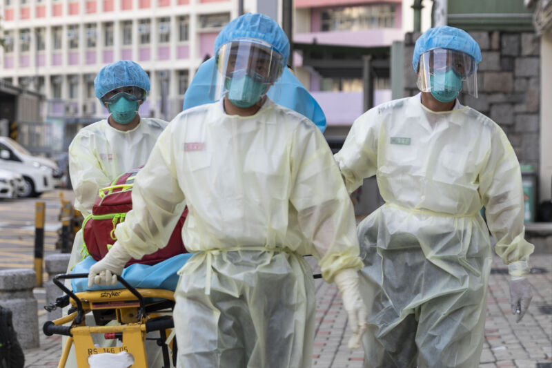 Medical staff wearing personal protective equipment (PPE) as a precautionary measure against the COVID-19 coronavirus approach Lei Muk Shue care home in Hong Kong on August 23, 2020. 