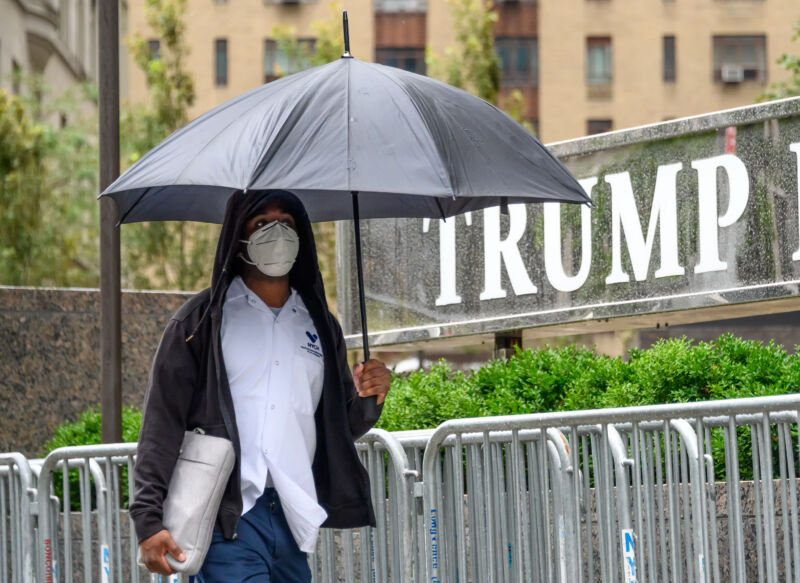 A person wears a protective face mask outside Trump International Hotel & Tower New York.