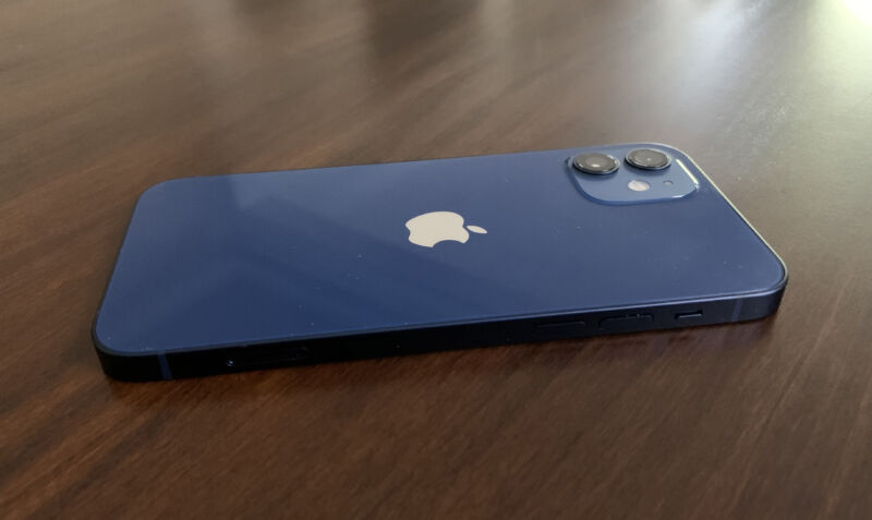 A blue iPhone 12 lying flat on a table