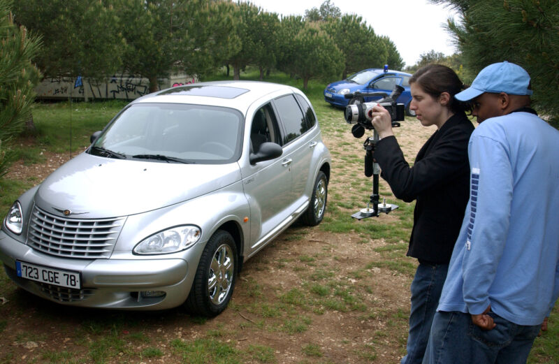 Director Maurice Dwyer leads the cast and crew in his production of "Cop Block," which prominently featured the Chrysler PT Cruiser, at the 2002 Cannes Film Festival.