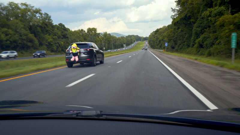 Would you notice if a large pink bear in a high-vis vest drove past you on the highway?