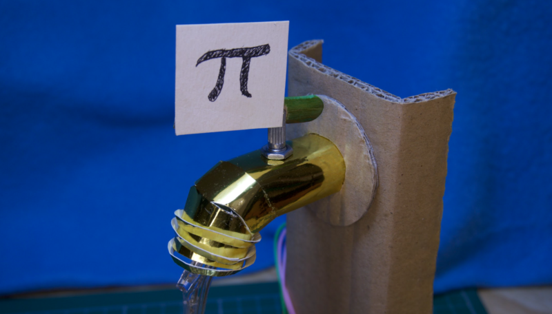 A close-up of the spigot, which is constructed from shiny gold card with a cardboard stand