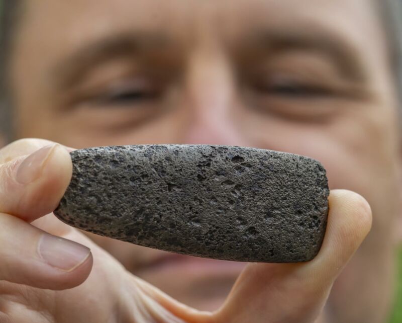 Florida Museum archaeologist Charles Cobb holds an axe head known as a celt, one of more than 80 metal objects likely from the de Soto expedition. To create this distinct shape, a Chickasaw craftsperson reworked Spanish iron to mimic traditional stone versions.