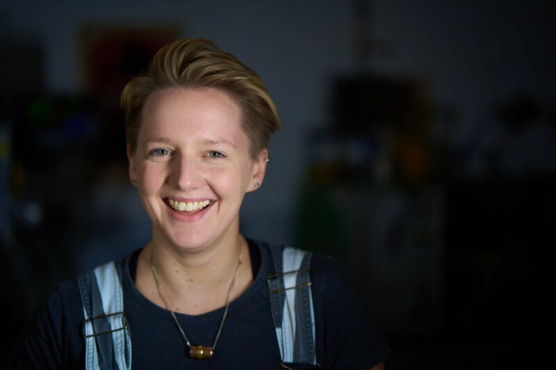 anna ploszajski smiling in a blue top