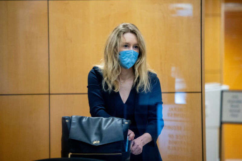 Theranos founder Elizabeth Holmes collects her belongings after going through security at the Robert F. Peckham Federal Building with her defense team on August 31, 2021, in San Jose, California.