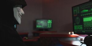 a person with mask using a computer