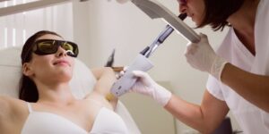 doctor-performing-laser-hair-removal-patient-skin