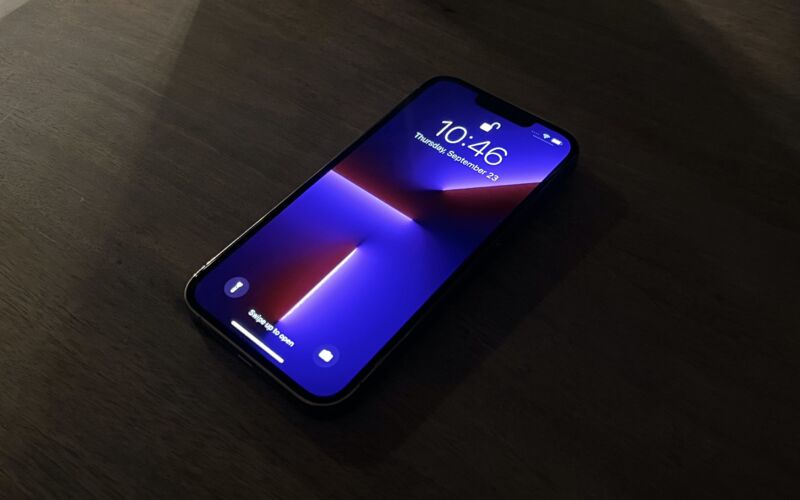 A large OLED screen on a desk in a dark room