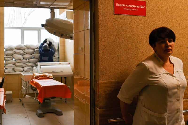 A nurse waits as another staff places sand bags near the window for protection in Kramatorsk City Hospital in eastern Ukraine.
