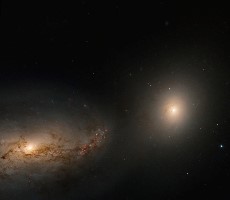 Stunning Hubble Image Captures Two Galaxies Dancing With A Cannibalized Cosmic Cadaver