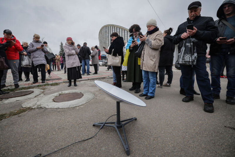 Local residents access the Internet from the Starlink network, set up by the Ukrainian army on November 13, 2022 in Kherson, Ukraine after the city was liberated from Russian occupation.