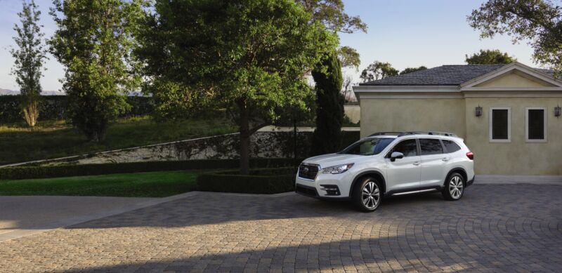 A white Subaru Ascent next to a suburban house