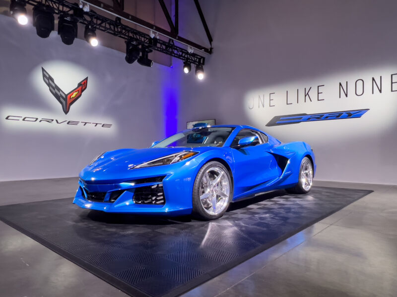 A blue Corvette E-Ray in a studio